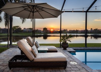 pool with 2 lounge chairs and umbrella